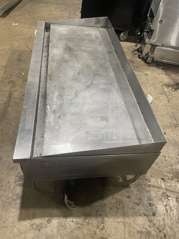 Garland commercial stainless steel countertop gas griddle on legs, used condition, features flat cooking surface.