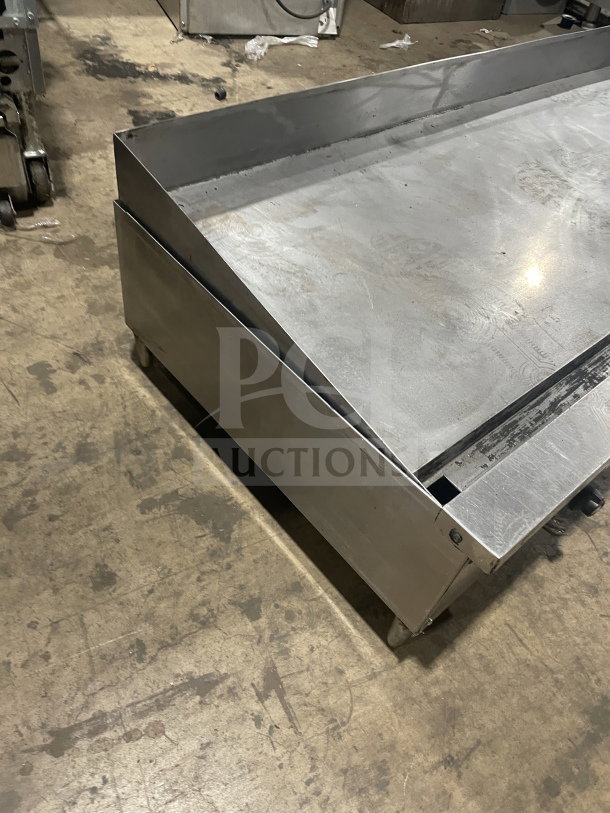Garland stainless steel countertop gas griddle with legs. Features durable design, used condition. Ideal for commercial kitchens.