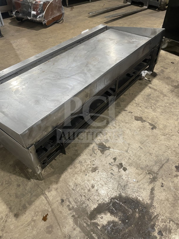 Garland commercial stainless steel countertop gas griddle on legs, showing minor wear, ideal for restaurant use.