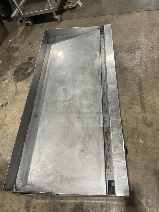 Garland stainless steel gas griddle; countertop design with legs; visible wear; ideal for commercial use.