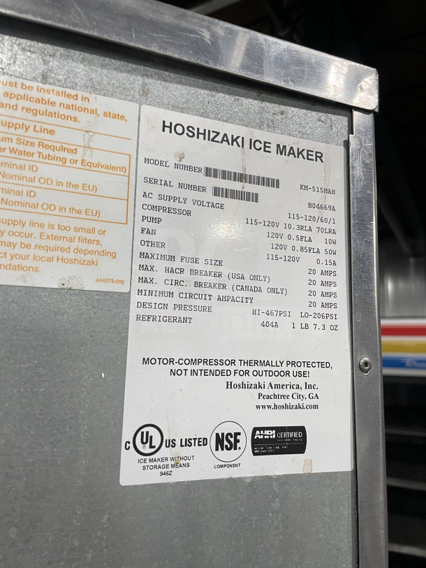 Hoshizaki KM-515MAH stainless steel ice maker with bin, electric, air-cooled, on legs, model and serial number visible.