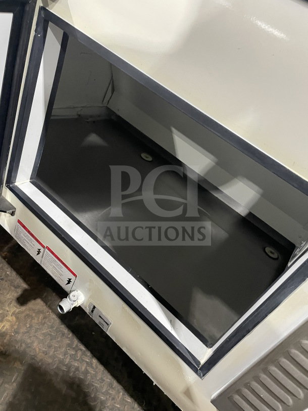Tor-Rey TEC13OL UL refrigerated deli merchandiser, 57" curved glass, two-tier, rear glass sliding doors, 120V, prominent interior.