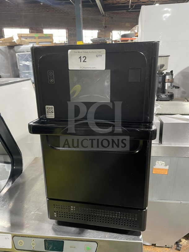 MerryChef Eikon E2S black electric countertop rapid cook oven, serial number 2205213093138; minor wear, auction tag visible.