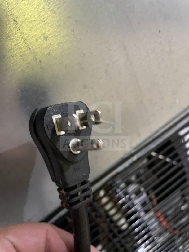 Close-up of a 115V power plug for Turbo Air TST-28SD-D2-N refrigerated prep table, showing prongs and cord.