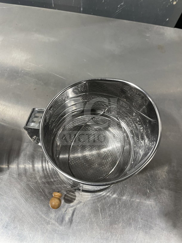 Mrs. Anderson's stainless steel flour sifter, model 28015, hand-crank design, new condition, wooden knob handle.