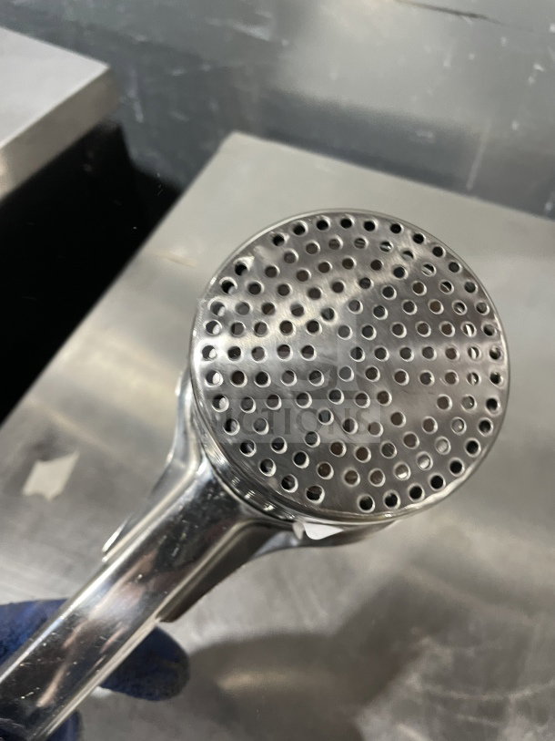 Winco PR-9 stainless steel potato ricer, commercial grade, new condition, round design, perforated plate.