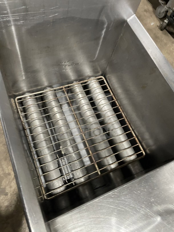 Cecilware Commercial Stainless Steel Gas Fat Fryer with back splash, on legs. Features heating elements and sturdy construction.