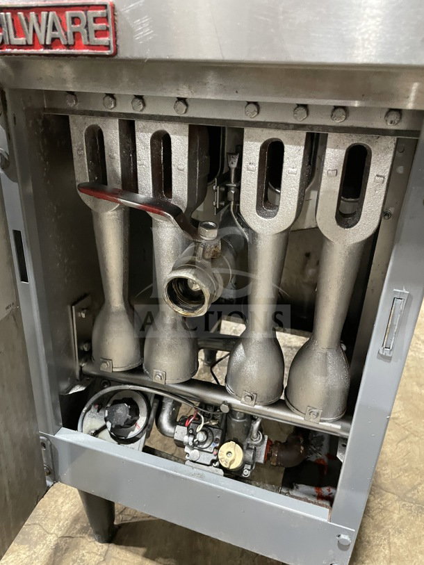 Cecilware stainless steel gas-powered fat fryer with backsplash, on legs. Interior view shows components and "Cecilware" label.