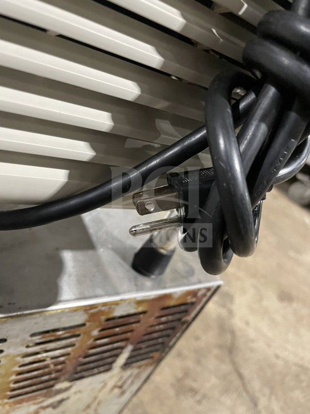 Crathco D354 beverage machine close-up, showing power cord and vents on stainless steel base, 115V, used condition.