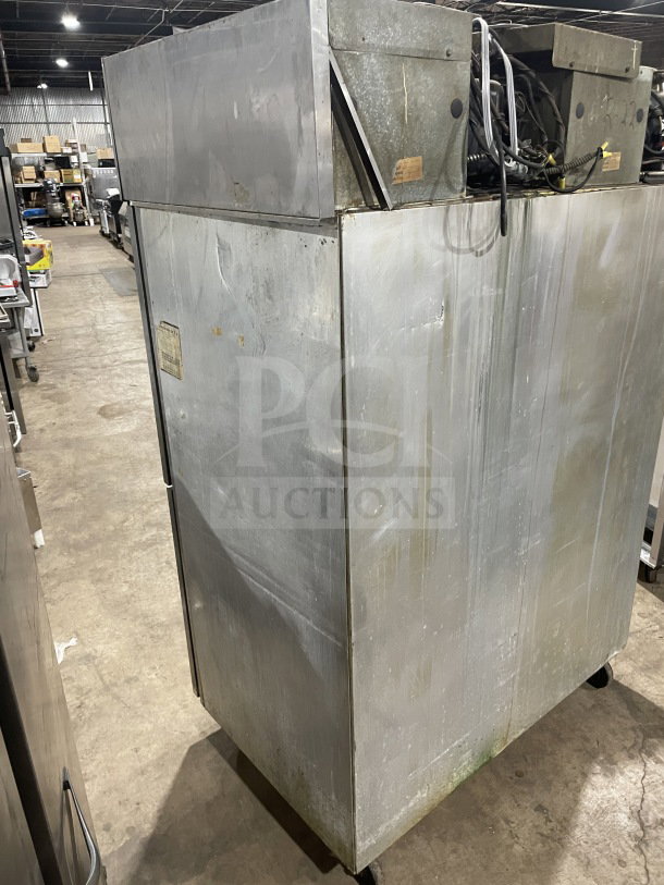 Delfield/Alco commercial stainless steel 4-door refrigerator, dual-zoned, on casters, poly-coated wired rack, visible wear.