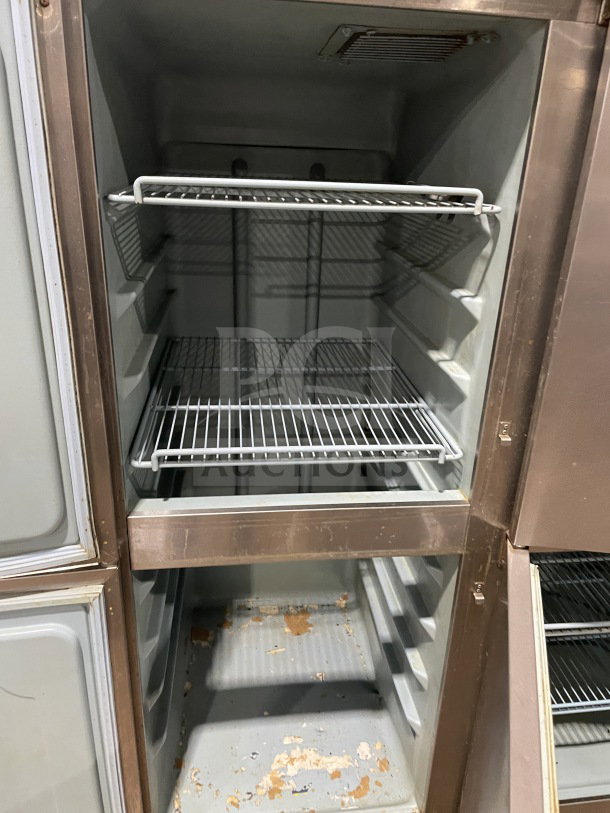 Delfield/Alco stainless steel 4-door dual-zoned refrigerator with poly-coated racks on casters, showing interior shelving.