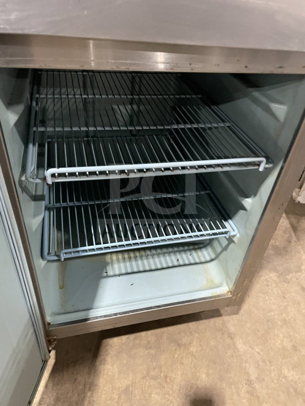 Delfield/Alco stainless steel 4-door refrigerator with poly-coated wire rack. On casters. Dual-zoned for commercial use.