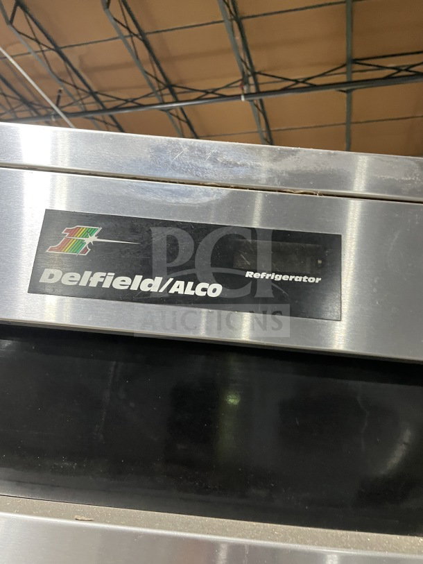 Delfield/Alco Commercial Stainless Steel 4-door refrigerator, dual-zoned, with poly-coated wire racks, on casters.