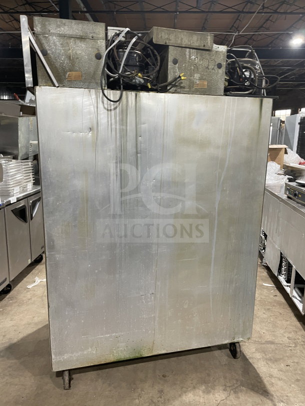 Delfield/Alco stainless steel 4-door dual-zoned refrigerator with poly-coated wired rack, on casters, visible wear.