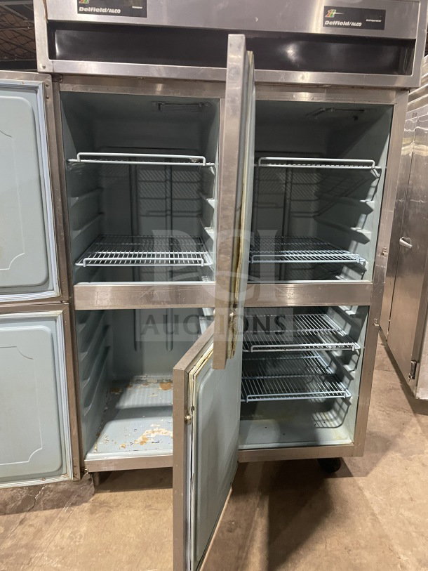 Delfield/Alco commercial stainless steel 4-door dual-zoned refrigerator with poly-coated wired racks on casters; used condition.