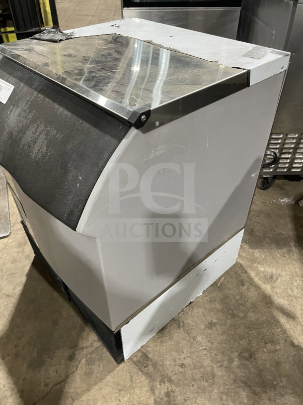 Ice-O-Matic commercial under-counter ice machine, 115V, 1 phase. Stainless steel top, used condition, slight wear visible.