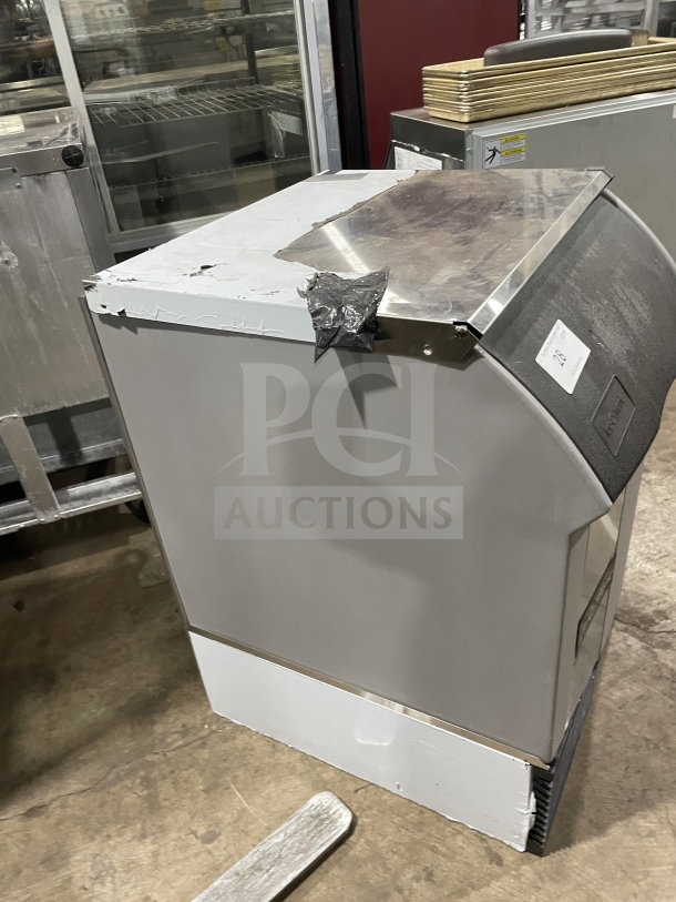 Ice-O-Matic under-counter ice machine, 115V, 1 phase. Shows wear with duct tape on top; model markings and serial number visible.