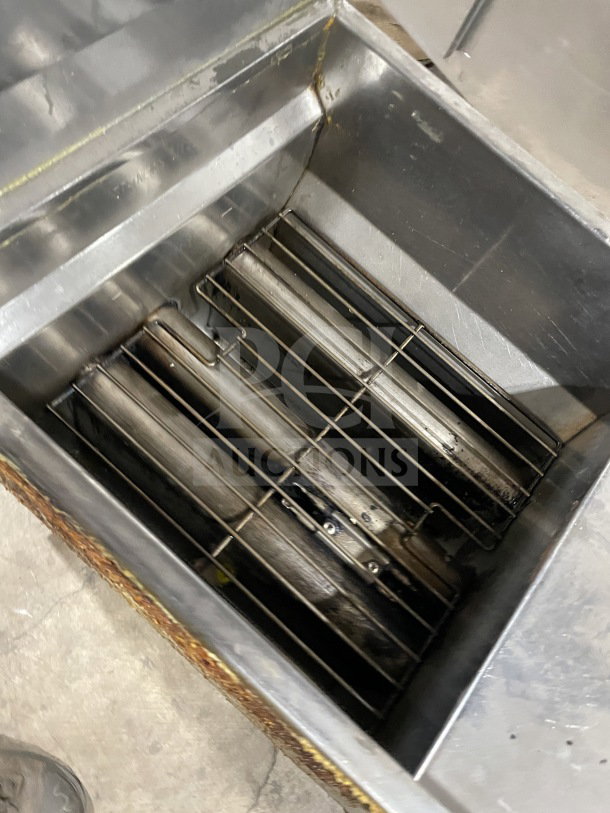 Commercial stainless steel gas-powered fryer with backsplash, on casters. Features visible heating elements, in used condition.