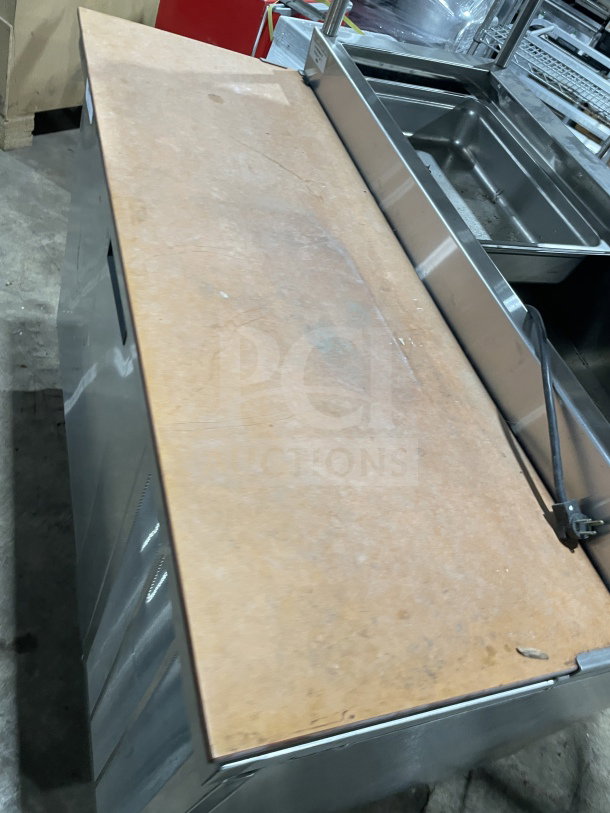 Delfield stainless steel pizza prep table with enclosed storage, double overhead shelf, chrome rack, 115V 1 Phase, on legs.