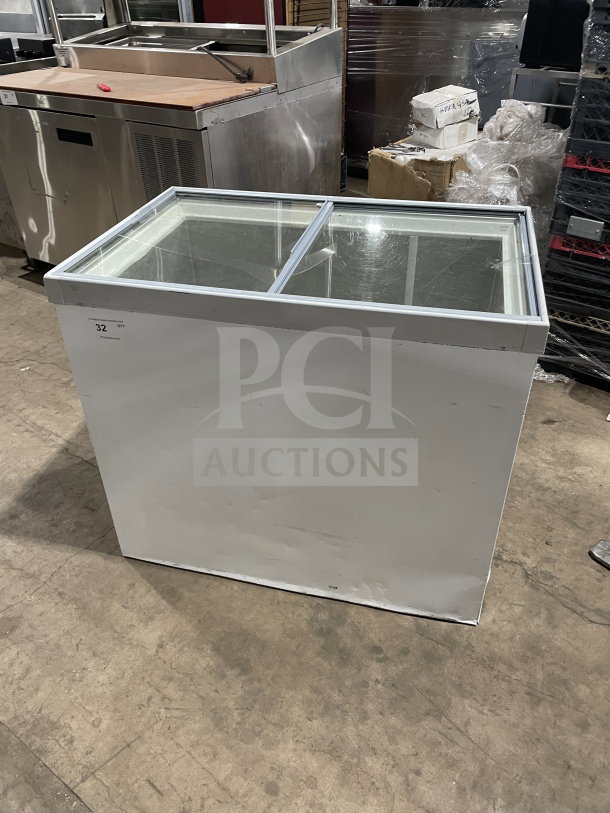 Commercial white curved glass 46" ice cream dipping cabinet. Rear lift-open access. Slight wear, ideal for retail settings.