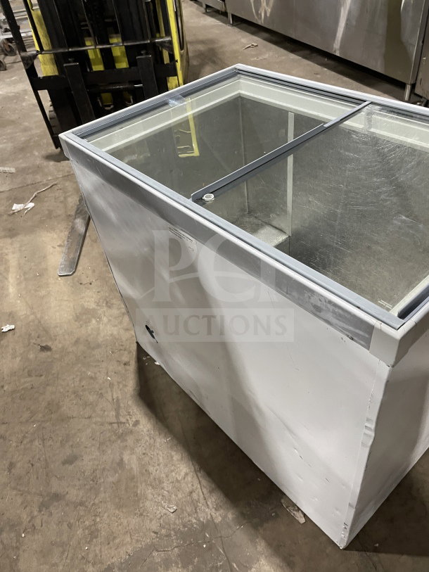 Commercial white curved glass 46" ice cream/frozen yogurt dipping cabinet with rear lift-open access. Good condition.