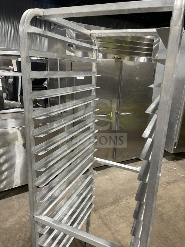 Commercial stainless steel heavy-duty pan sheet/bun pan rack with multiple slots, on casters, in good condition.