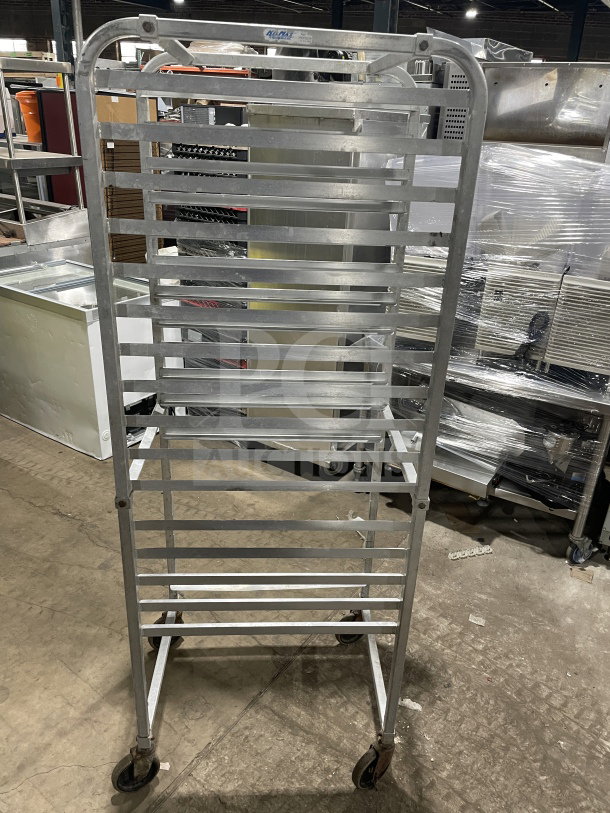 Commercial heavy-duty stainless steel bun pan rack on casters, multiple shelves, good condition, ideal for bakeries.