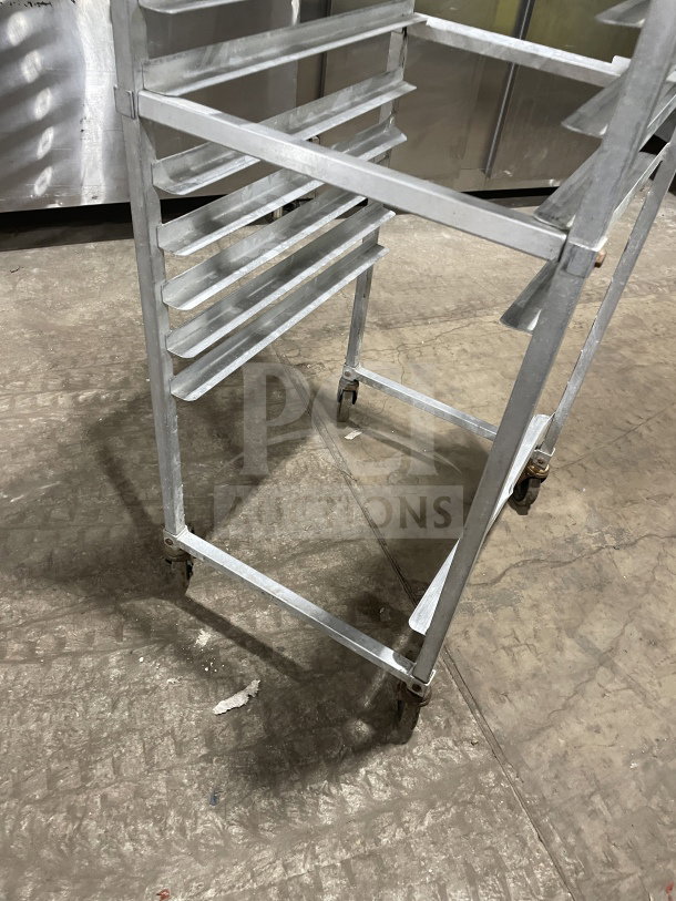 Commercial stainless steel heavy-duty pan sheet/bun pan rack on casters, sturdy frame with multiple slotted tiers.