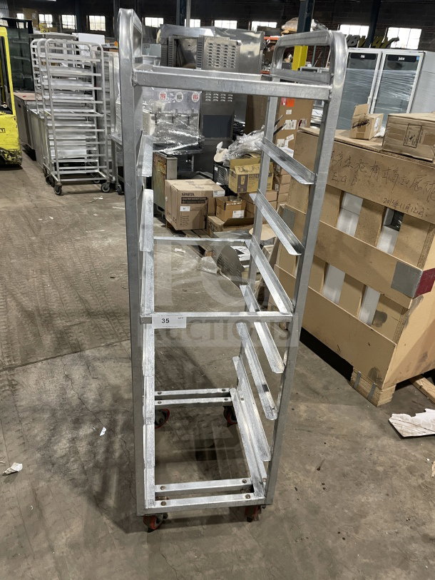 Channel stainless steel end load mobile bun/sheet pan rack with wire slides on casters, used, commercial-grade.