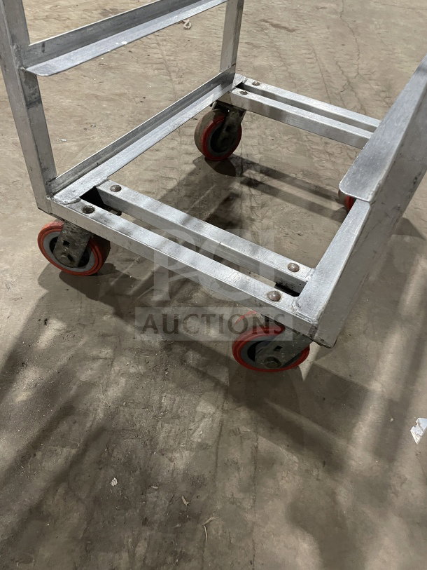 Channel stainless steel end load mobile bun/sheet pan rack on red casters. Wire slides, commercial-grade.