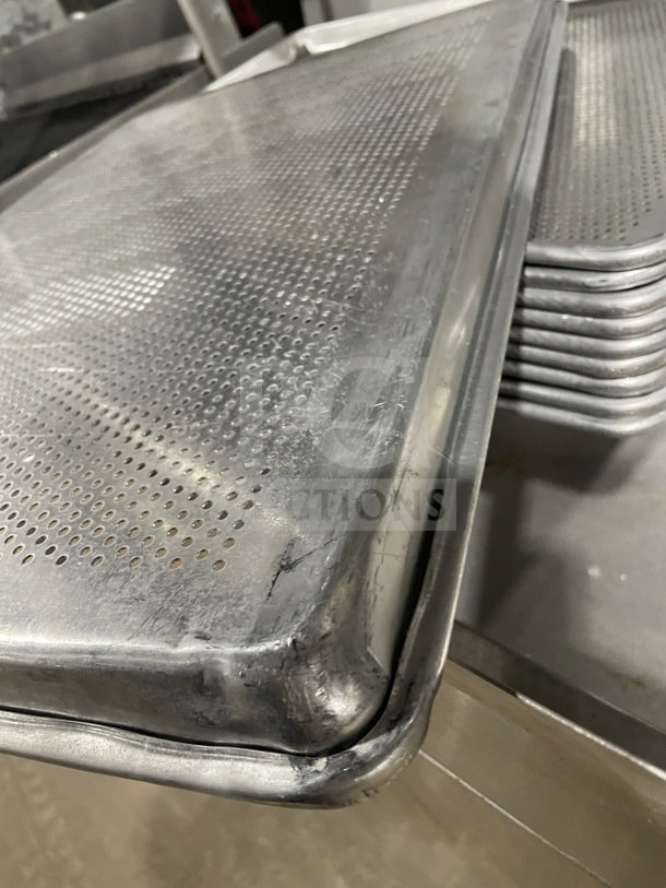 Commercial stainless steel full-size perforated sheet pan, durable condition, stack of pans shown, suitable for heavy-duty baking.