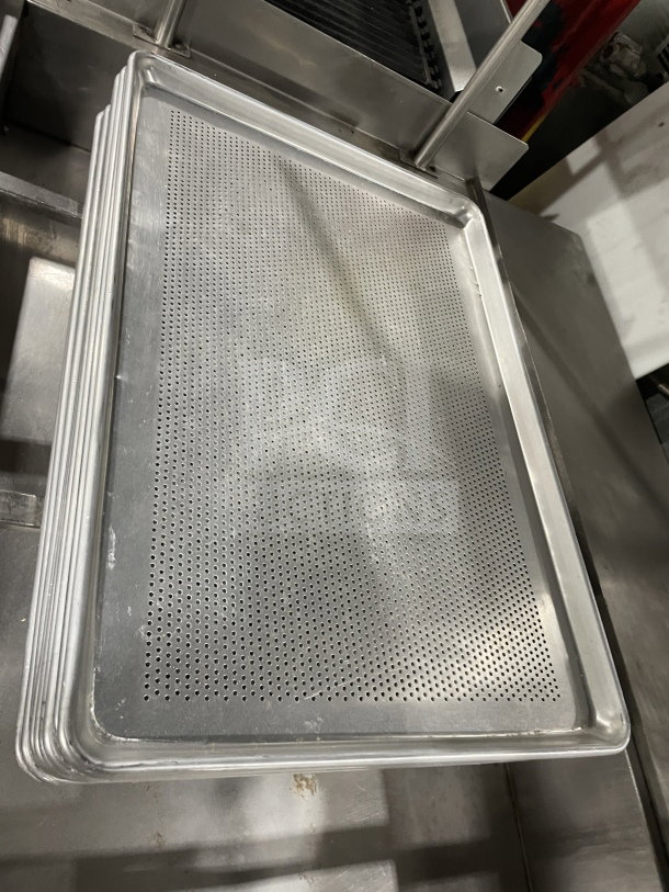 Commercial stainless steel full-size perforated sheet pan in good condition, ideal for professional kitchen use.