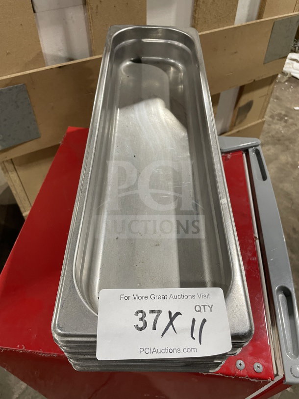 Winco commercial stainless steel full-size hotel pan, stack of 11, excellent condition. Handle visible. Auction label: "37X QTY 11".