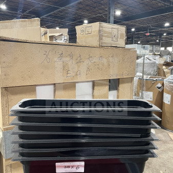 Carlisle black full-size food pan stack, good condition, 6 pieces. Label: "38 X 6" from PCIAuctions.com.
