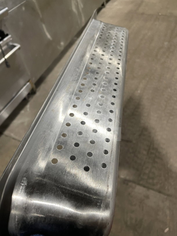 Choice Commercial Stainless Steel 2-1/2" Perforated Steam Pan, durable and in good condition, visible perforations.