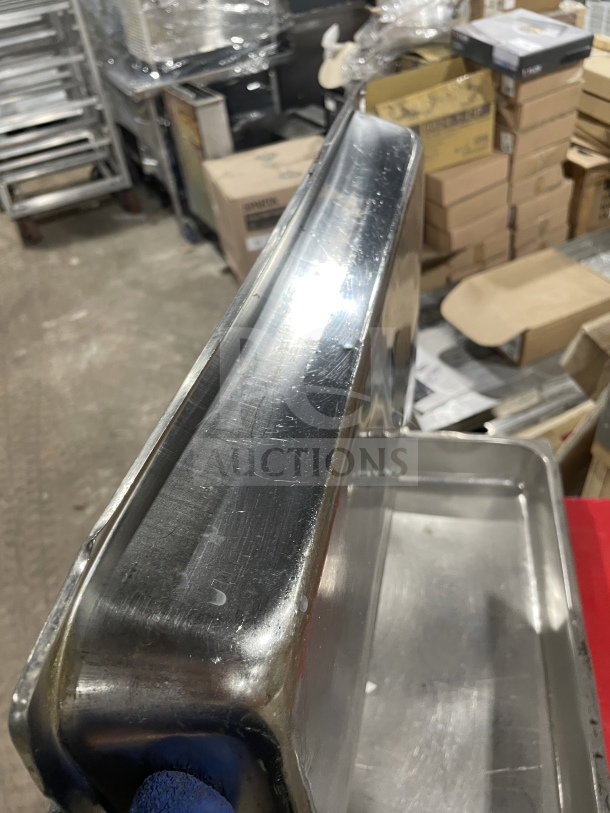 Commercial heavy-duty stainless steel full-size hotel steam table food pan in used condition, anti-jam design.