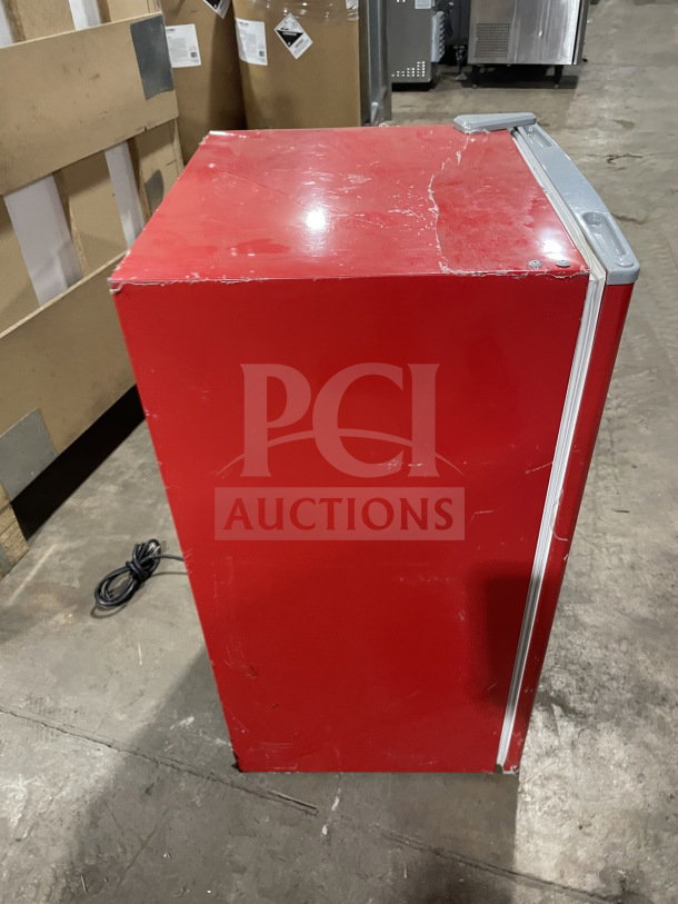 RCA red single-door refrigerator and freezer, model RFR320-B-RED-COM. Features poly coated wired rack, Energy Star, 115V. Surface shows wear.