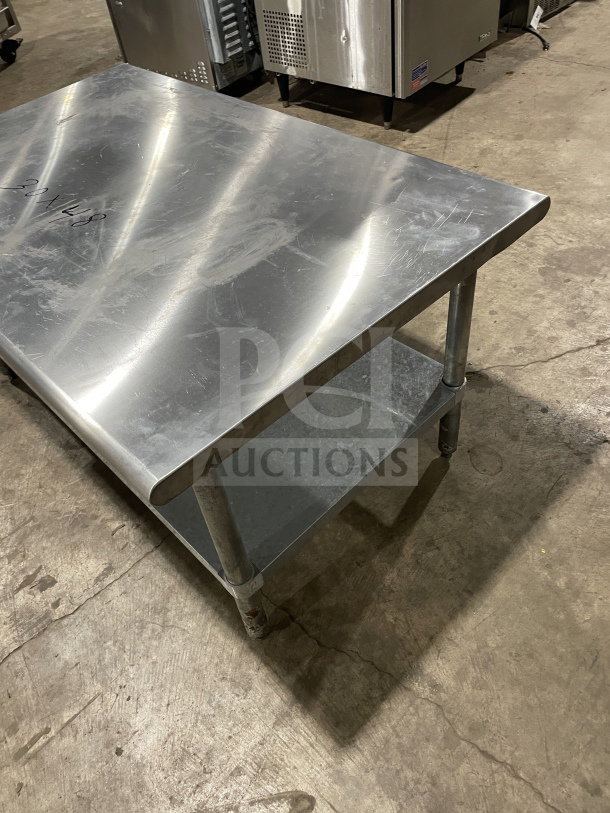 L&J stainless steel worktop table with undershelf on legs, used condition, dimensions 30"x48", sturdy and practical design.