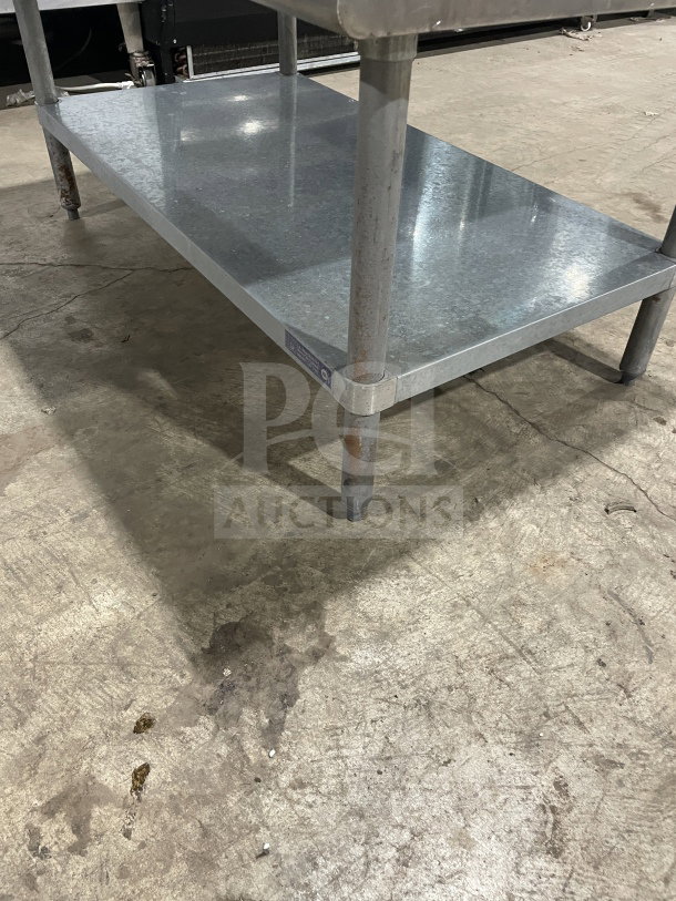 L&J Commercial stainless steel worktop table with single undershelf and legs, slight wear, durable for kitchen use.