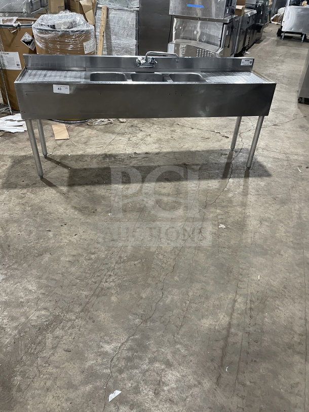 Krowne commercial stainless steel 3-compartment underbar sink with left and right side drainboards, backsplash, and legs.