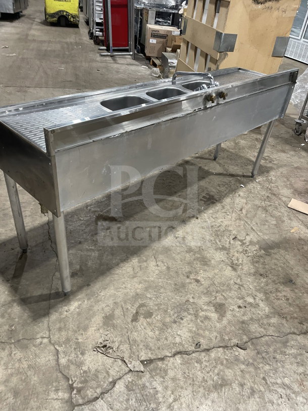 Krowne commercial stainless steel 3-compartment underbar sink with left and right drainboards, backsplash, and legs.