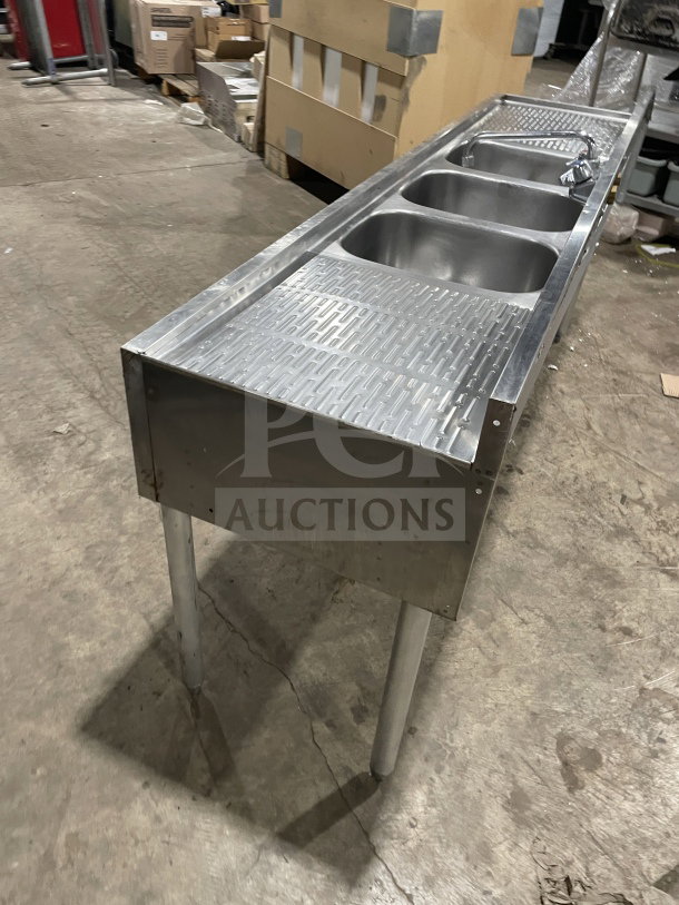 Krowne 3-compartment stainless steel underbar sink with left and right drainboards, backsplash, on legs. Good condition.