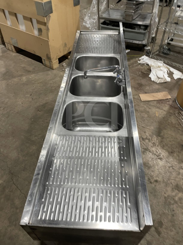 Krowne commercial stainless steel 3-compartment underbar sink with left and right drainboards, backsplash, and legs.