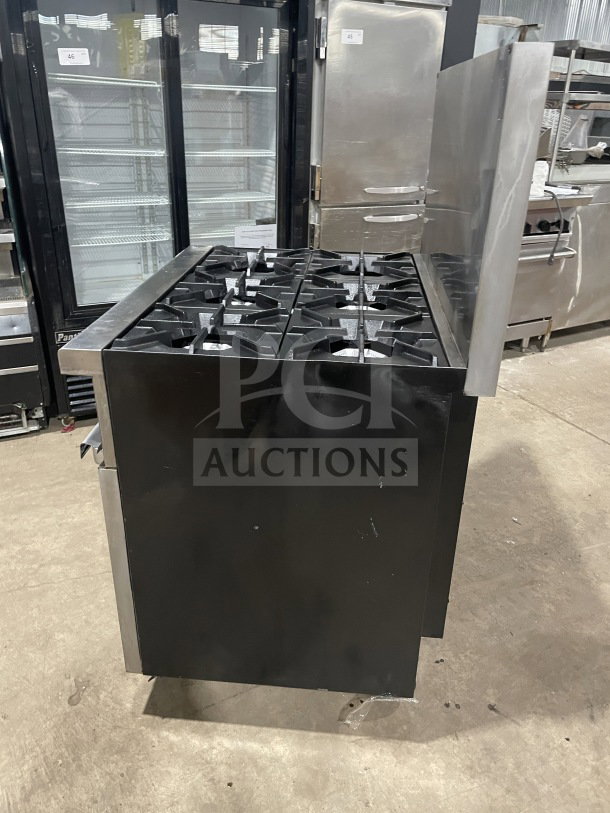 Commercial stainless steel 6-burner gas range/oven combo with backsplash, overhead salamander shelf, wired oven rack, and casters.