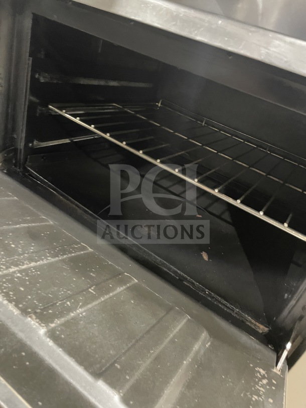 Commercial stainless steel 6-burner range/oven combo with backsplash, overhead salamander shelf, wired oven rack. On casters.
