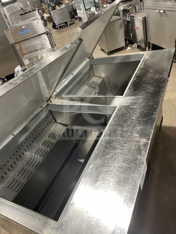Continental stainless steel 2-door refrigerated salad prep table, Model SW72 18, with wired rack, in good condition.
