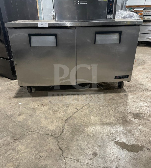 True TUC-60 commercial stainless steel 60" 2-door worktop refrigerator on casters, Energy Star certified, with upturned backsplash.
