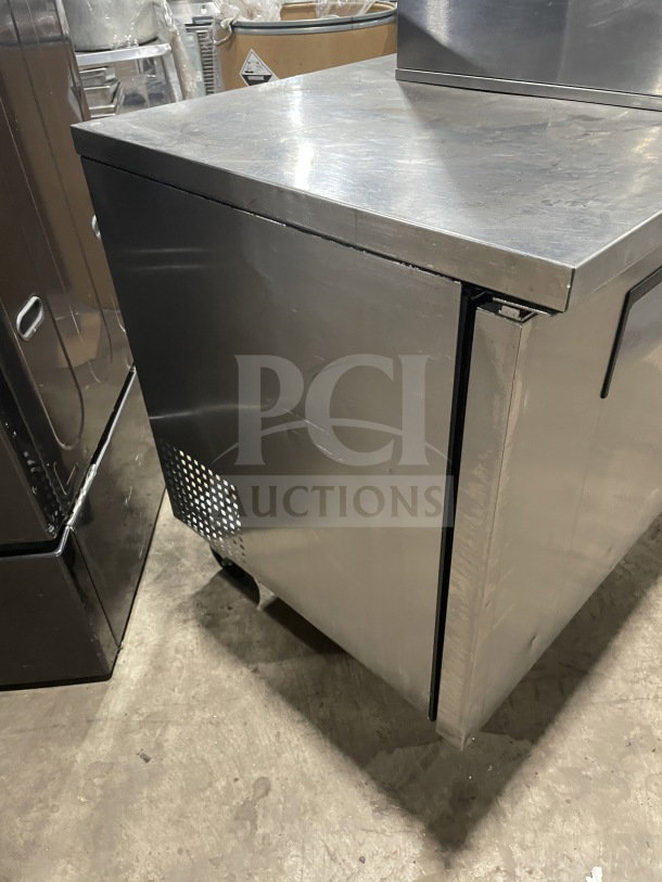 True TUC-60 stainless steel 60" 2-door worktop refrigerator, Energy Star certified, with upturned backsplash and casters.
