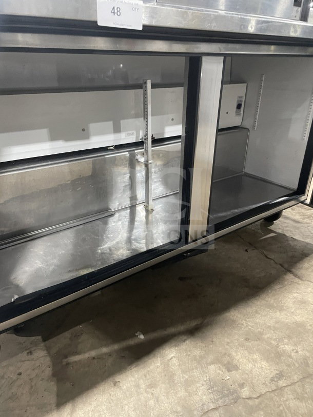 True TUC-60 worktop refrigerator, stainless steel, 60", 2-door, Energy Star certified, with upturned backsplash, on casters.