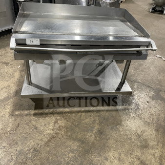 Vulcan 48" stainless steel flat griddle, model 48RRGCKR1, with back and side splashes, storage, and casters; excellent condition.